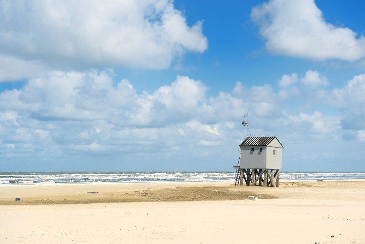 Drowning house at the beach from Dutch wadden island Terschelling